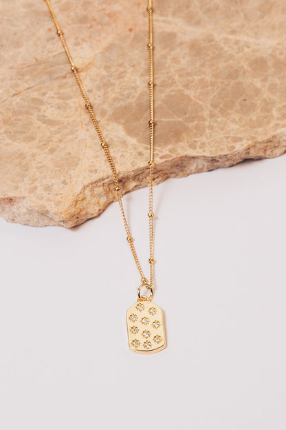 gold dog tag charm necklace on beaded chain