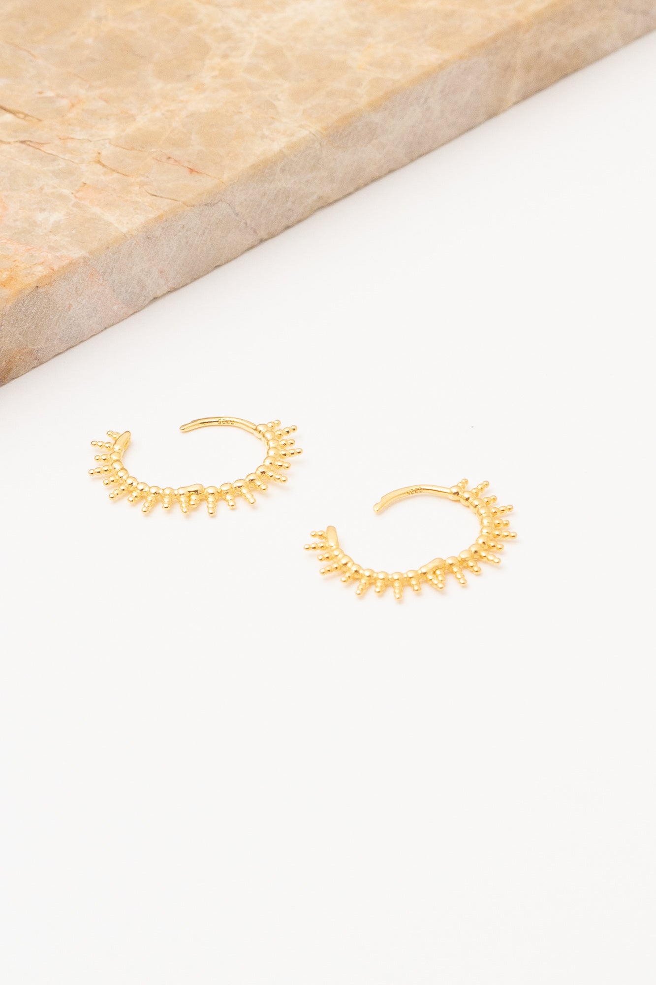 gold huggie hoop earrings open