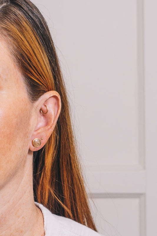 raw diamond stud earrings on red haired model