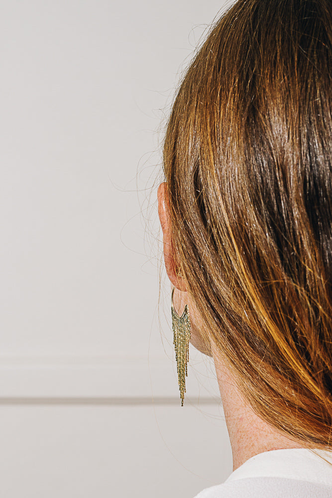 gold chain hoop earrings on model back view
