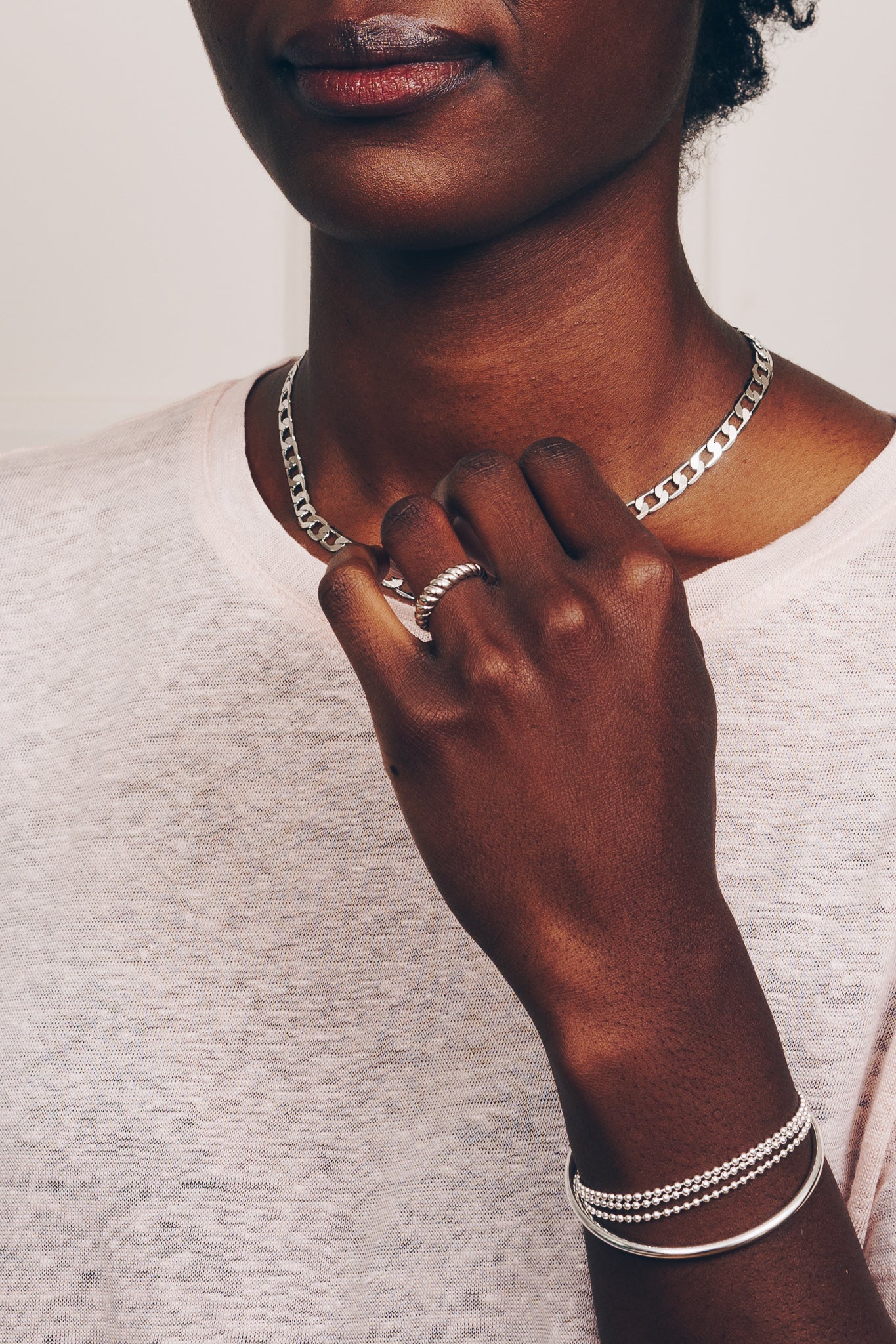 silver stacking ring on model with silver chain jewelry