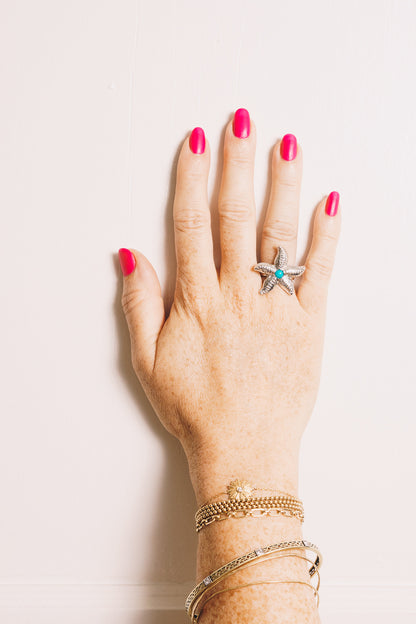 silver starfish ring with turquoise cabochon on model hand