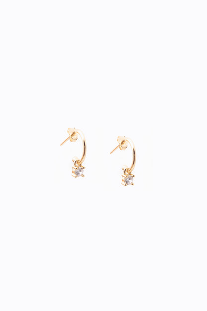 small gold crystal dangle hoops on white background 