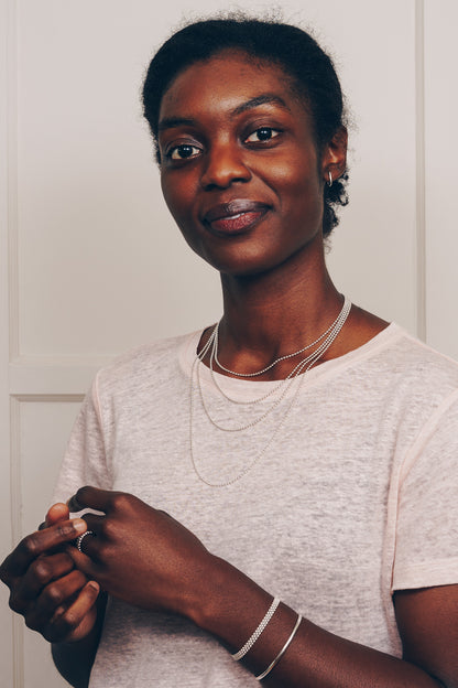 silver ball chain necklaces layered on model