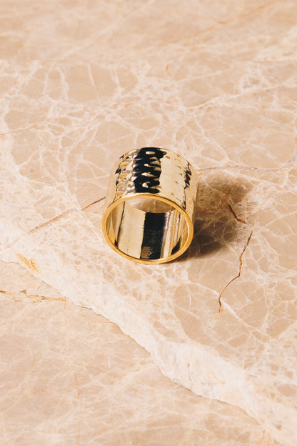 gold hammered cigar band ring on marble