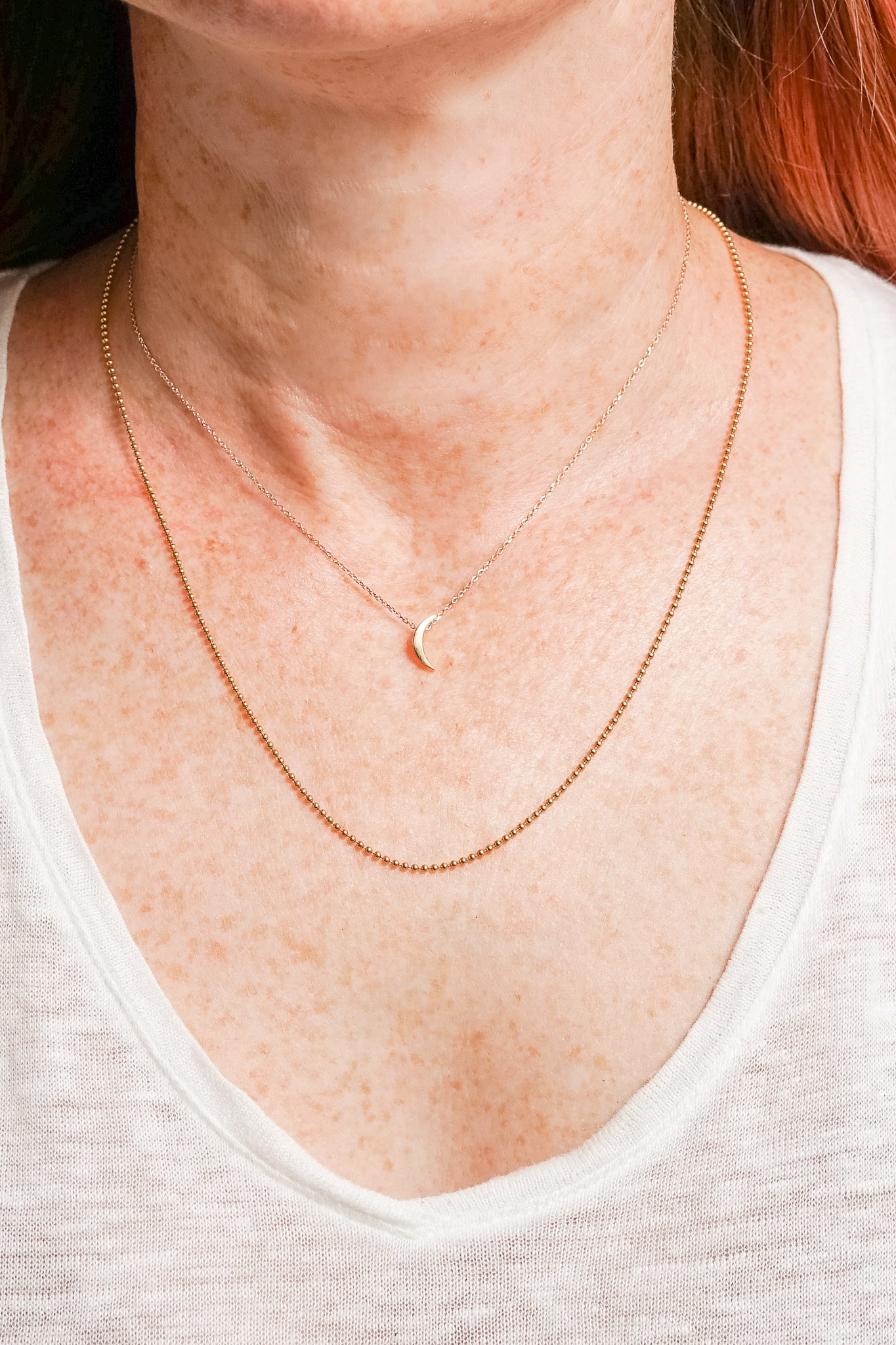 gold layering necklaces on model