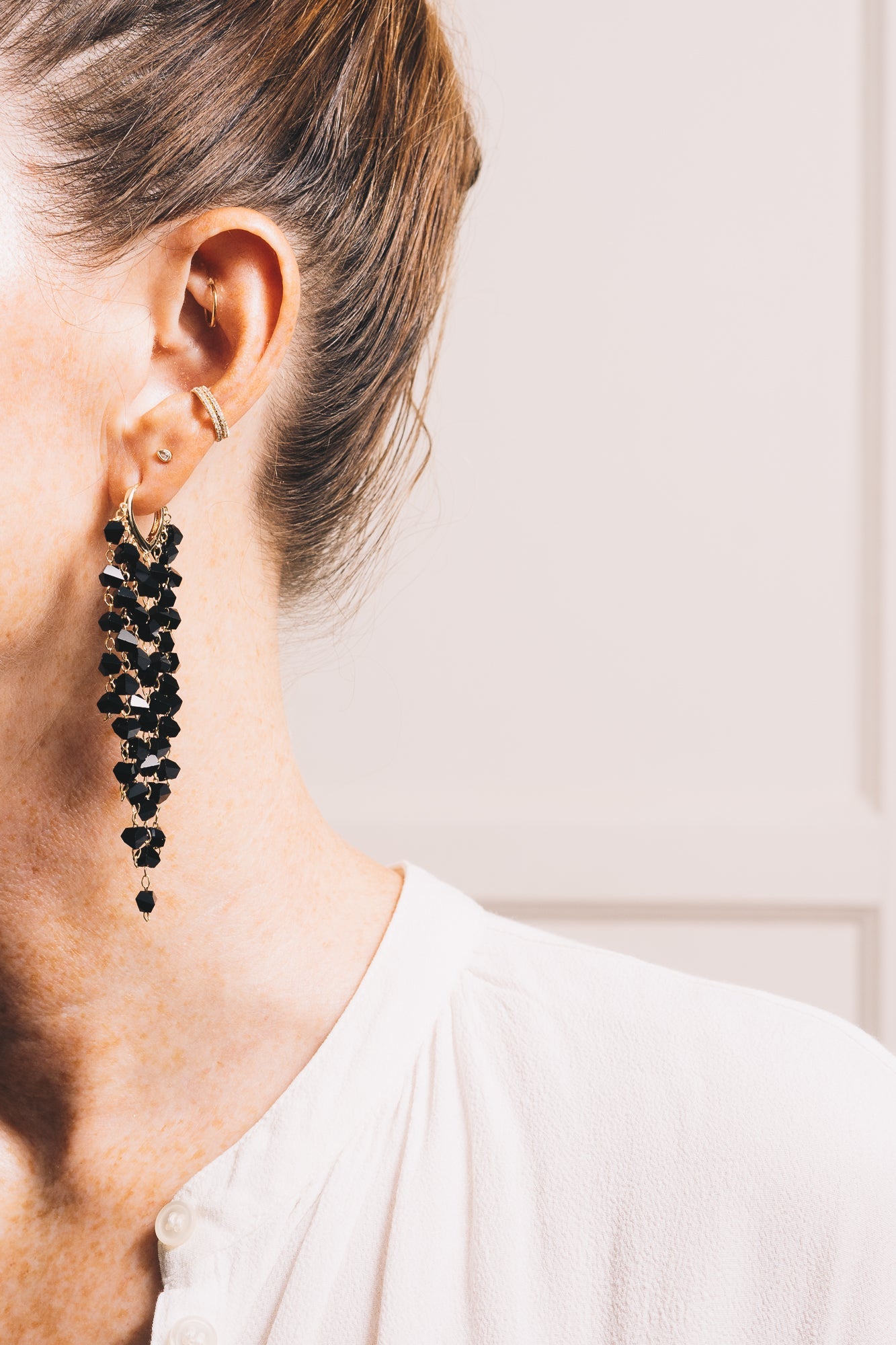 black crystal statement earrings on model side view