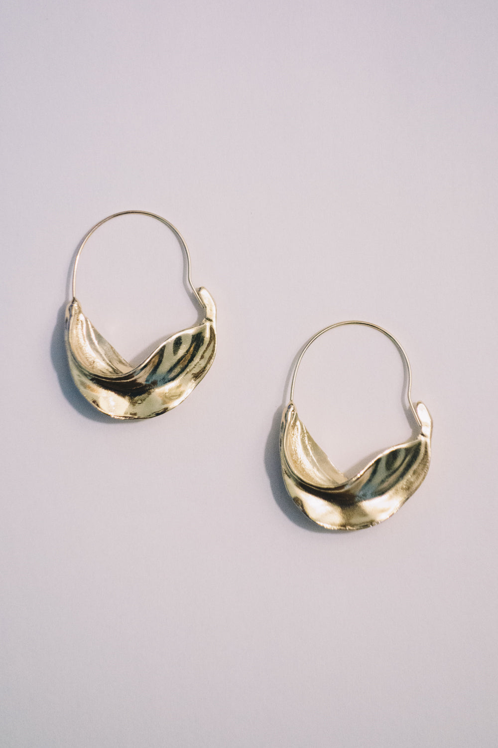 gold curved metal hoop earrings