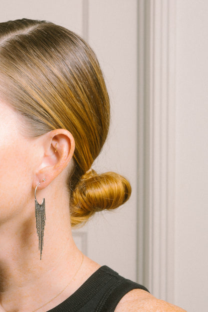 silver fringe earrings on model