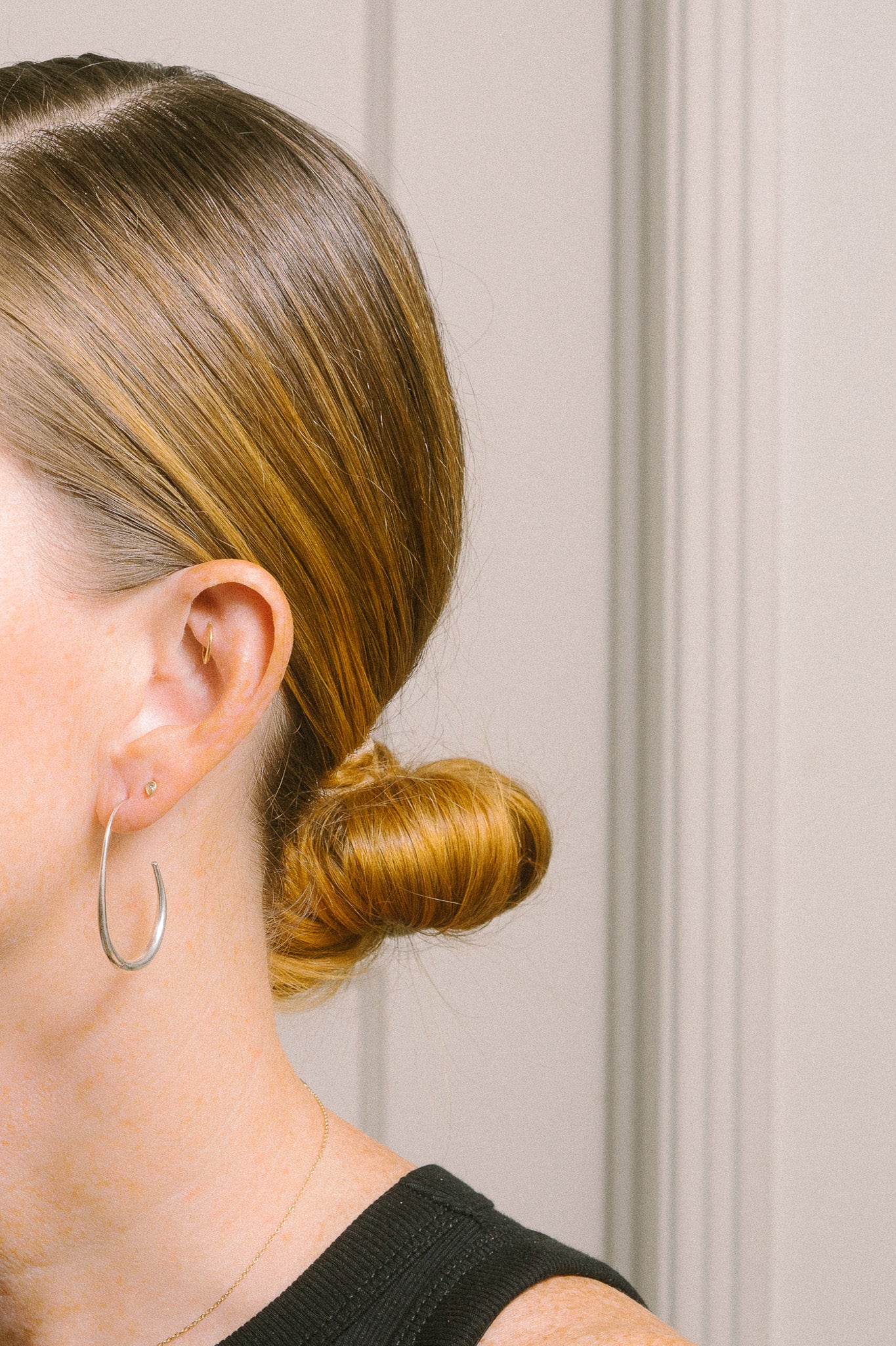 silver threader hoop earrings on model profile