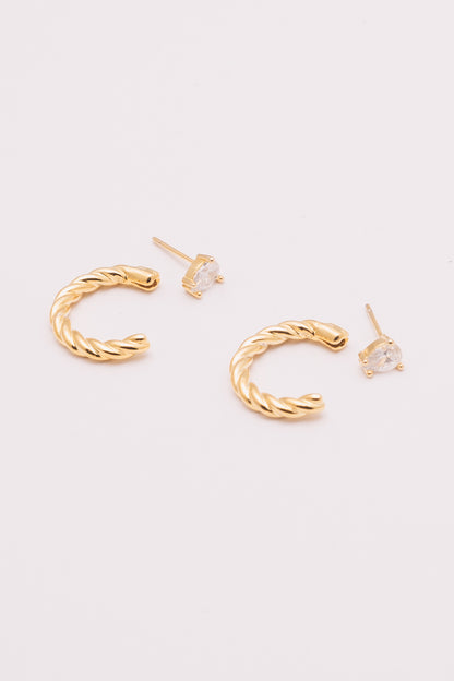 gold ear jacket hoops with crystal pear studs next to them