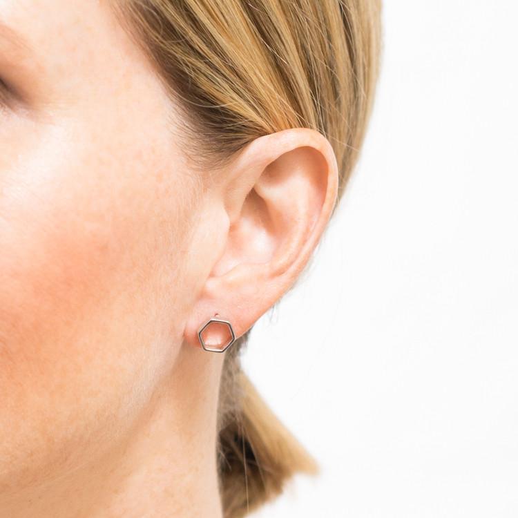 small hexagon stud earrings on model closeup