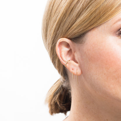 gold ear cuff on model with ear threaders