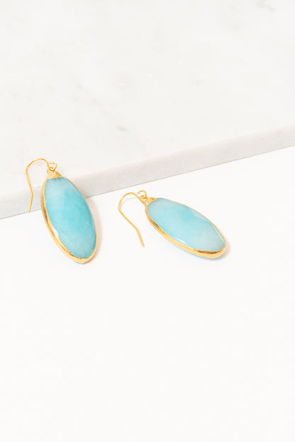 turquoise jade dangle earrings on marble