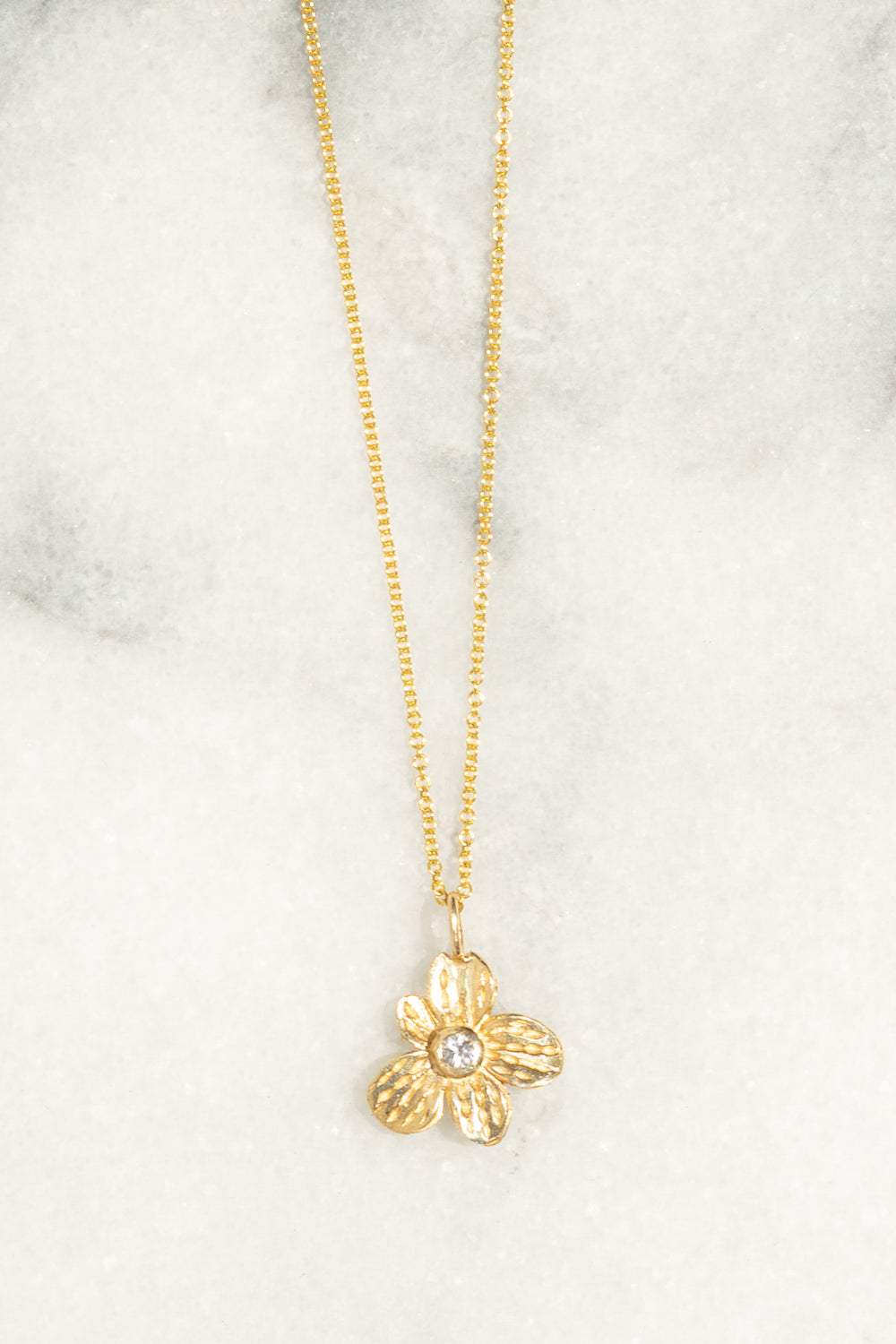 gold flower charm necklace white sapphire