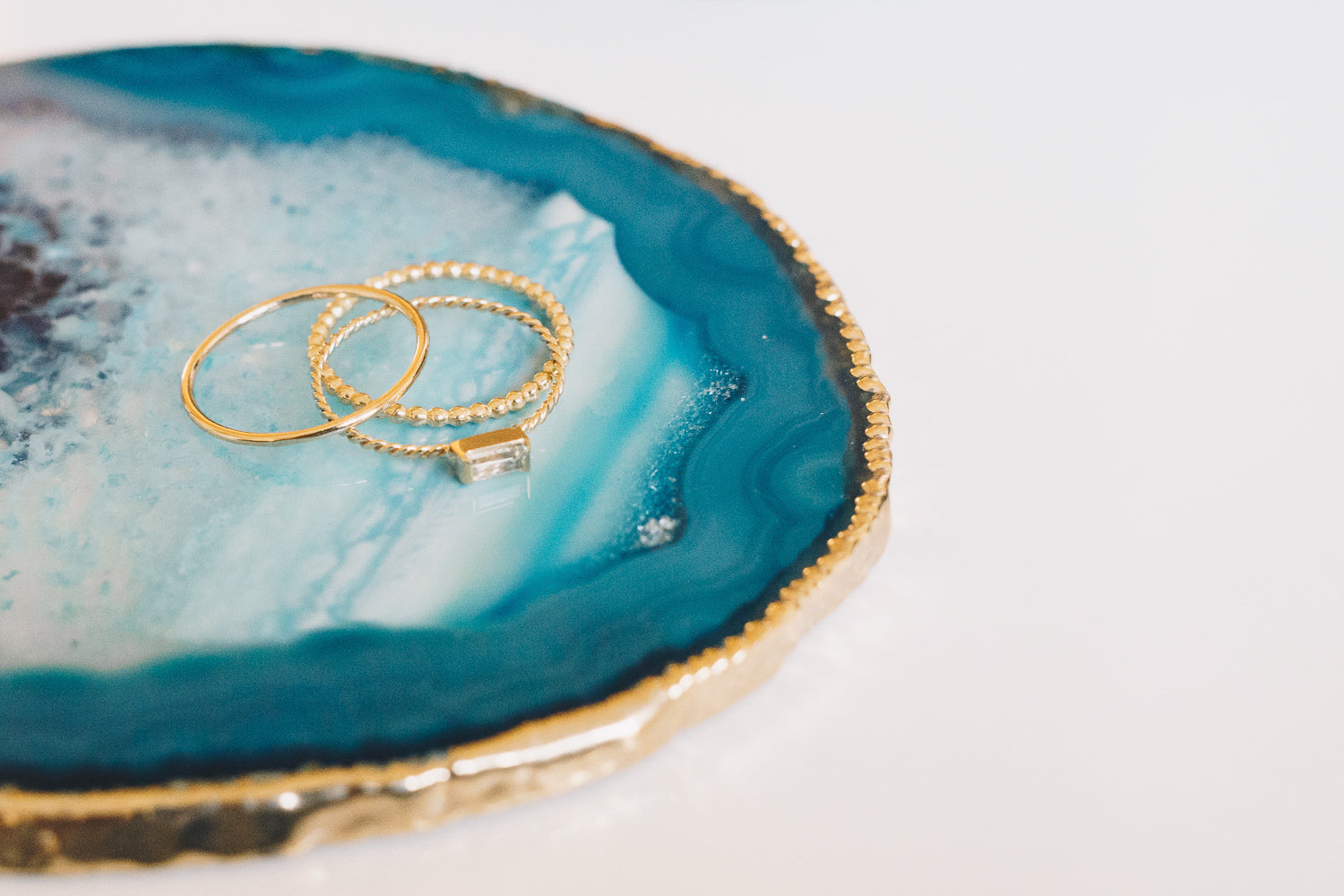 gold stacking rings on agate slice