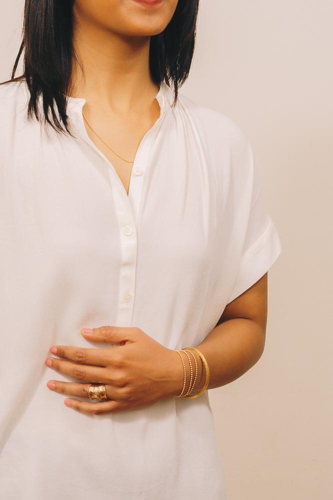 gold beaded bracelets layered with gold cuff bracelet