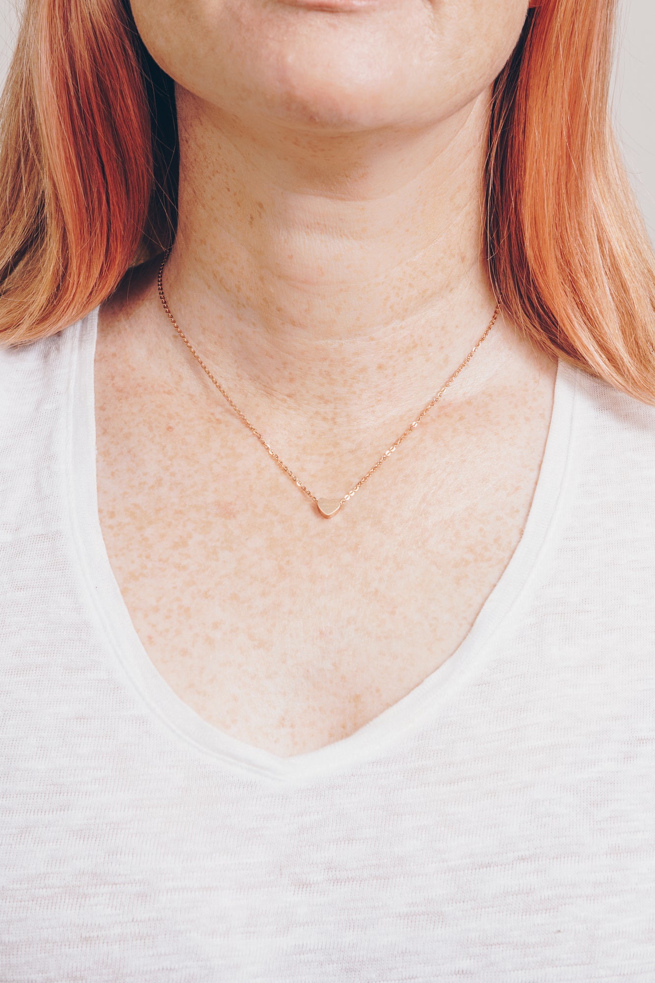 rose gold heart necklace on model