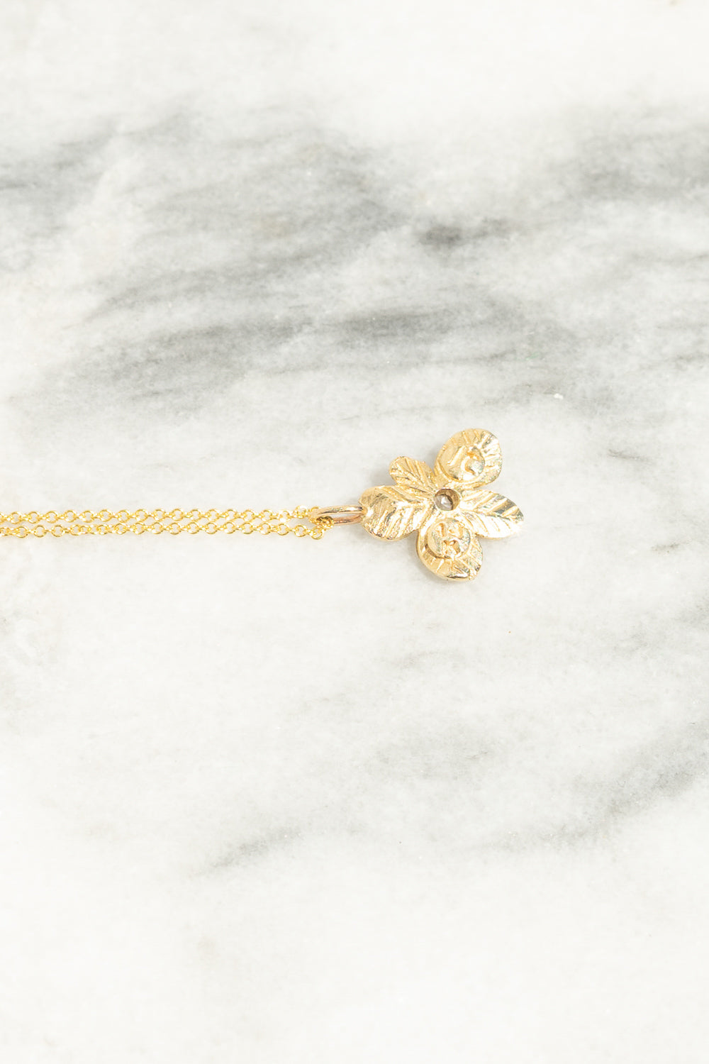 back view of gold flower charm pendant necklace