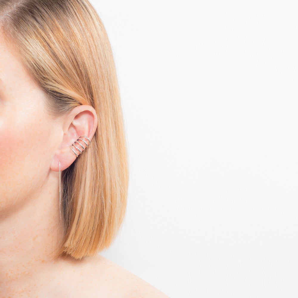 silver ear cuff earrings on model