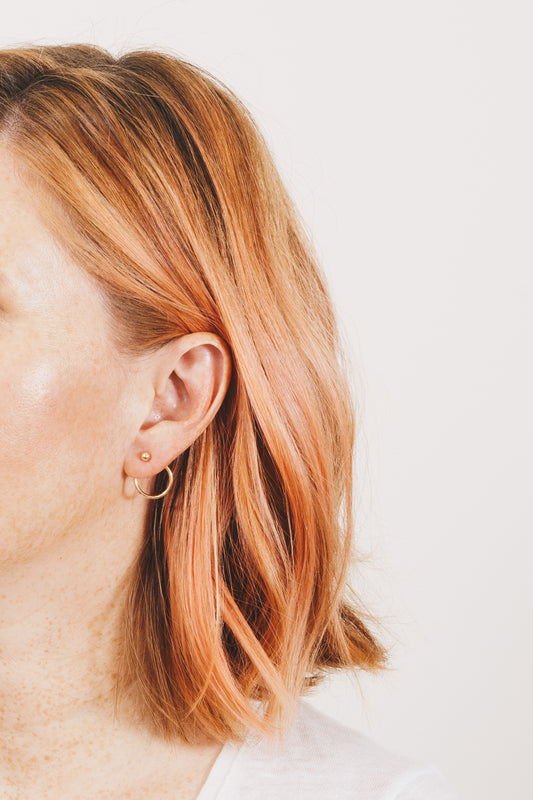 Janna Conner Solene gold hoop ear jacket earrings on model with strawberry blonde hair