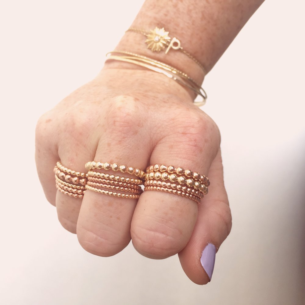 gold bubble stacking rings on model