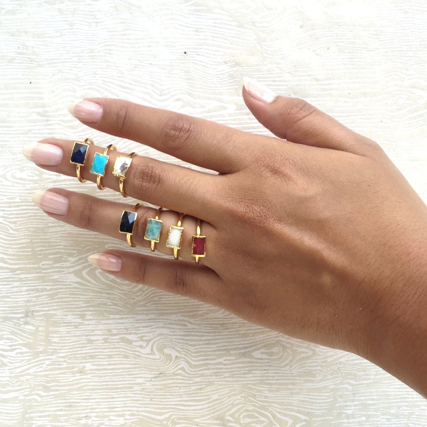 semi-precious stone stacking rings on hand