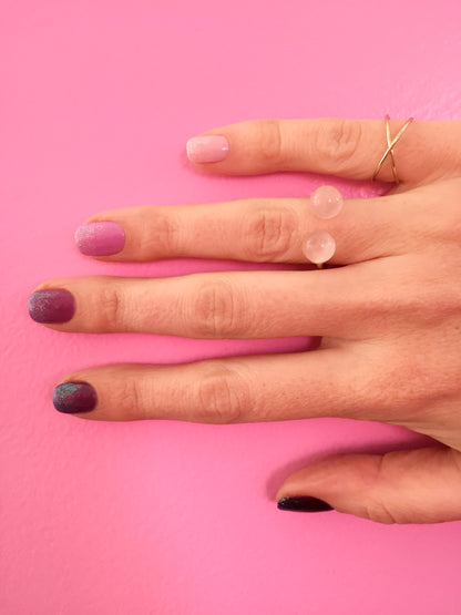 ombre glitter nails on model with rose quartz thibaut ring by janna Conner with pink wall