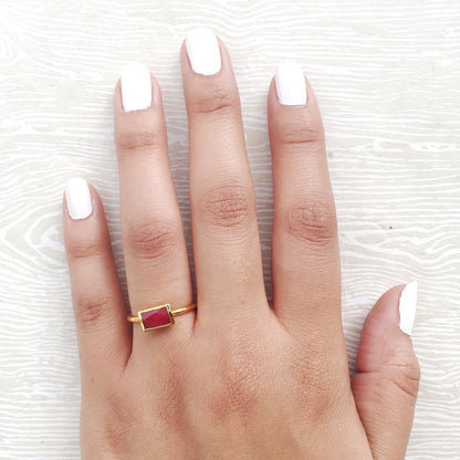 red semi precious stacking rings on hand