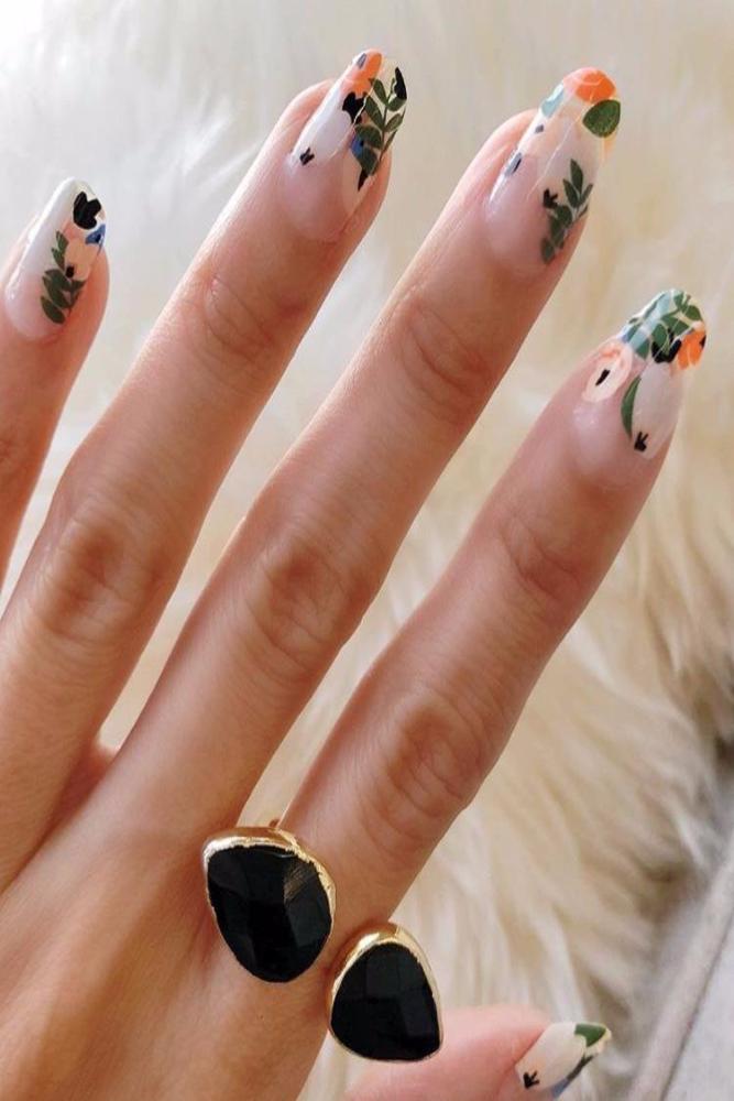 open stone ring on hand with flower nail art