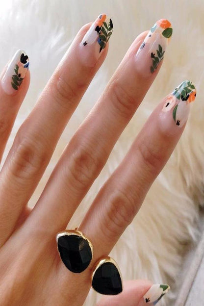 open stone ring on hand with flower nail art