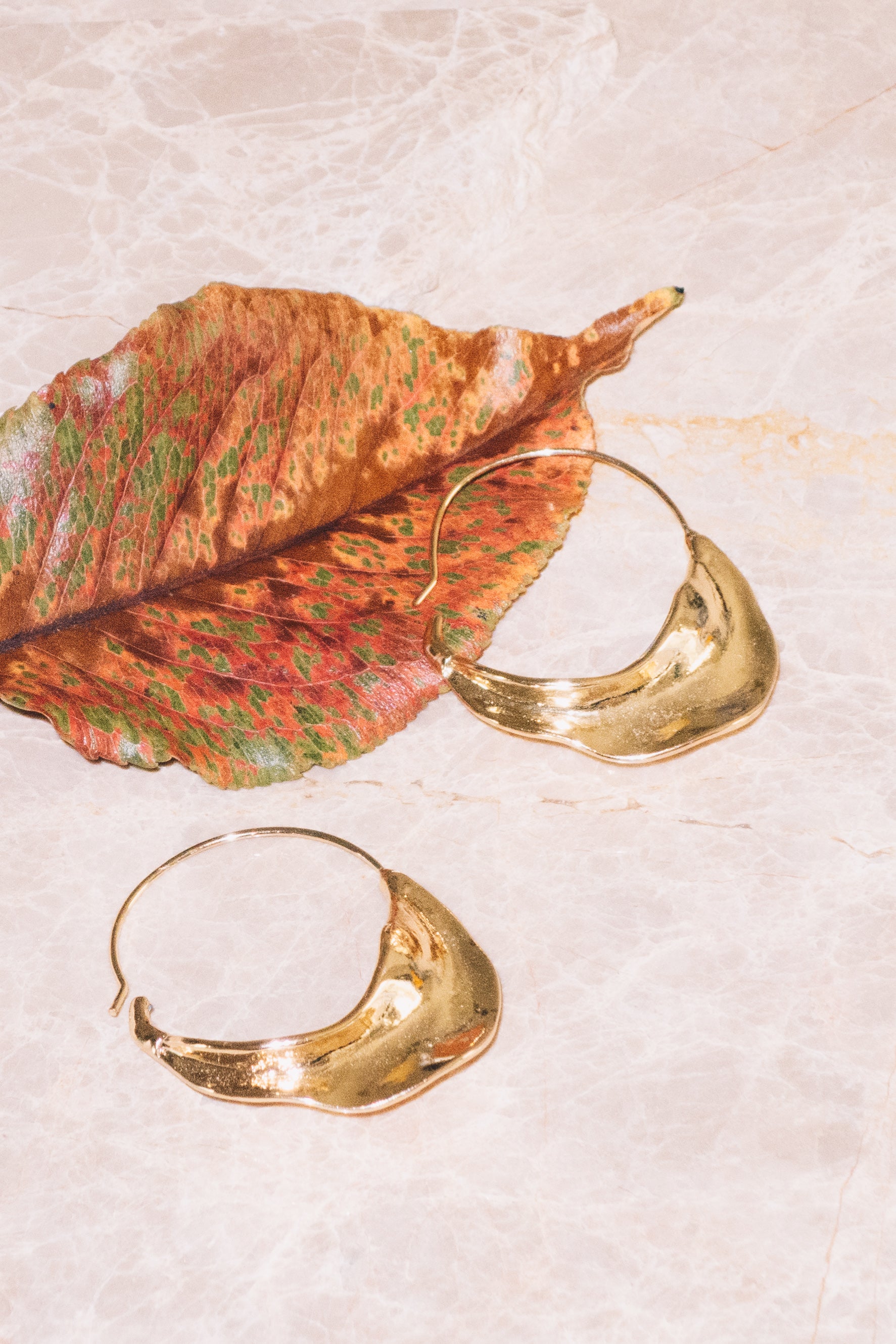 gold basket hoop earrings with fall leaf