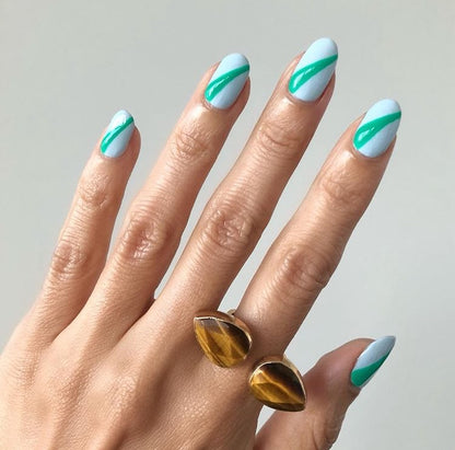 tiger eye open ring on hand with blue nail art